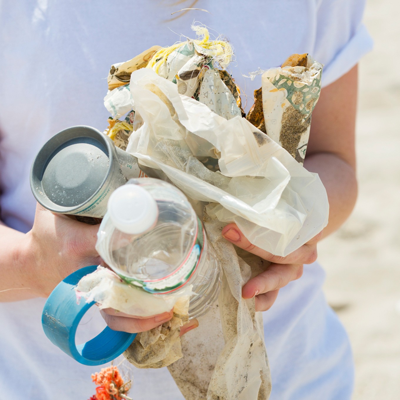 photo of person holding trash found on the beach