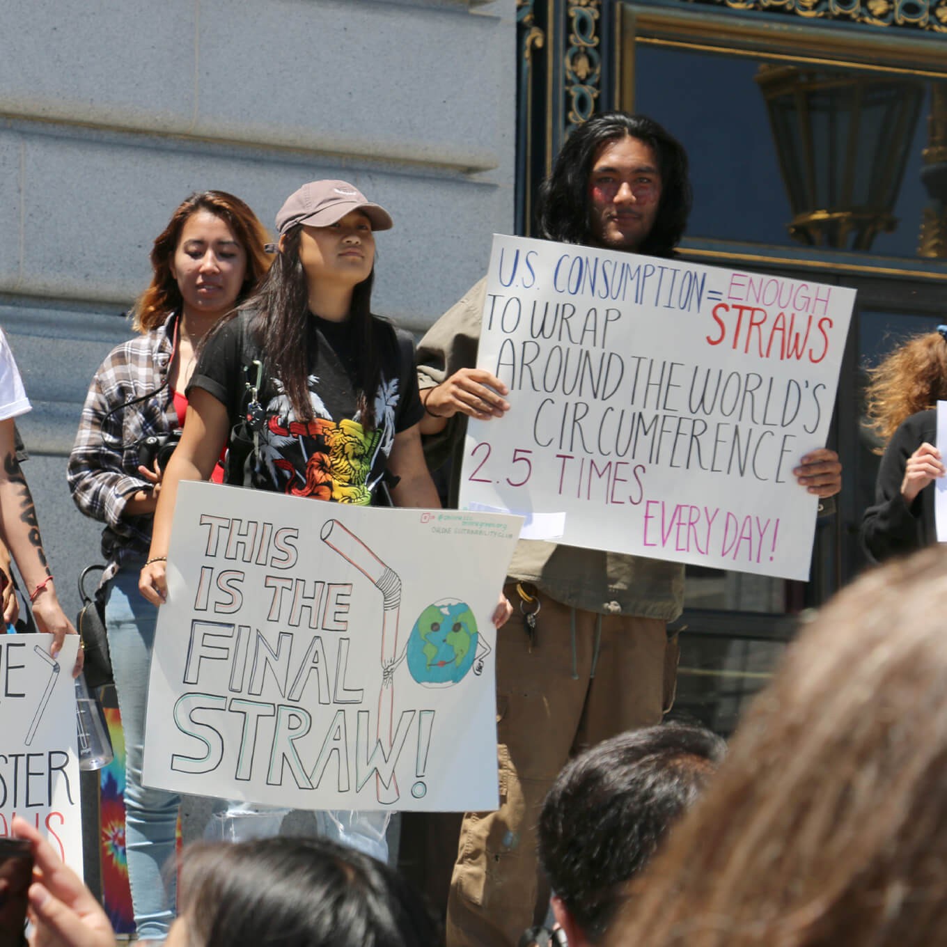 photo of activists holding signs about plastic pollution