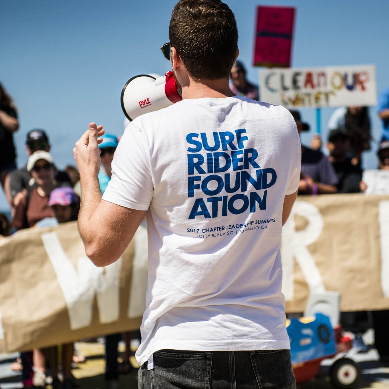photo of a Surfrider volunteer at an event with a megaphone 
